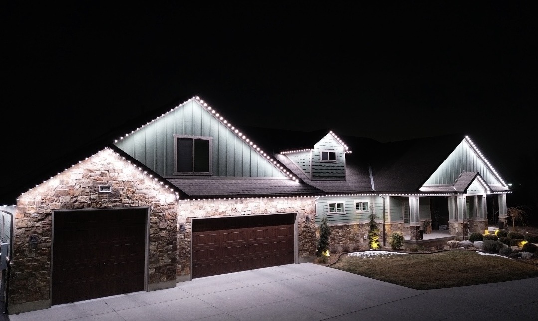 Cool White permanent roofline lighting on a home