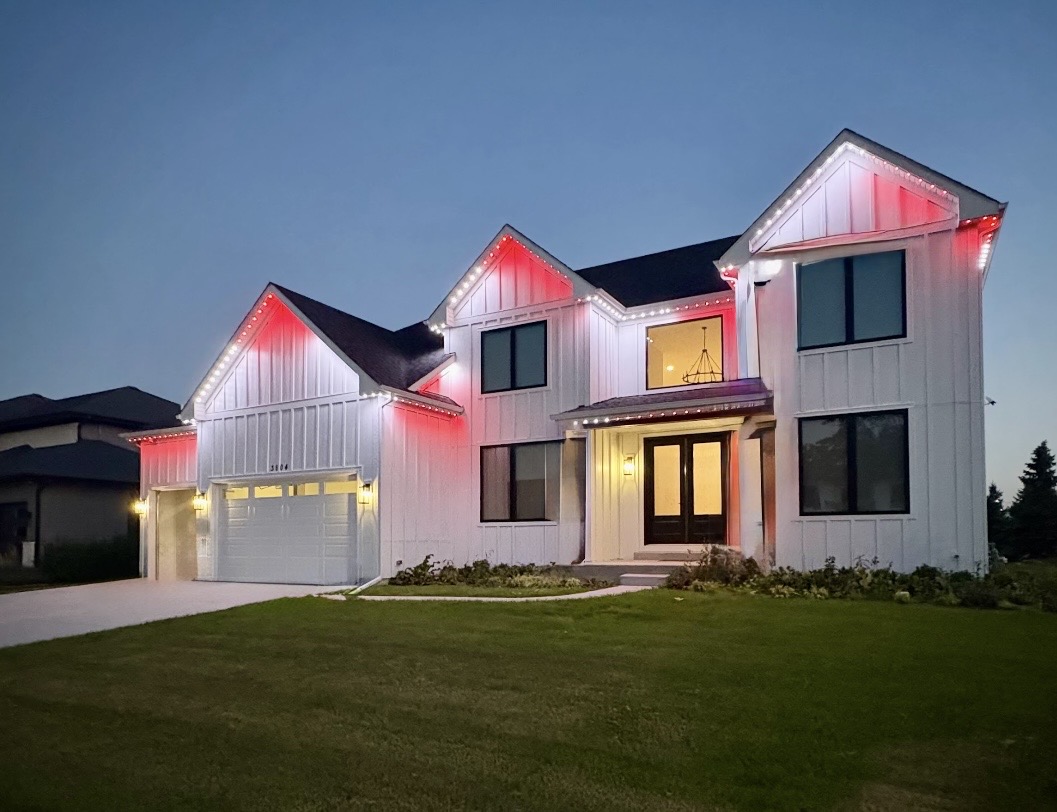 Red + White at Dusk permanent roofline lighting on a home