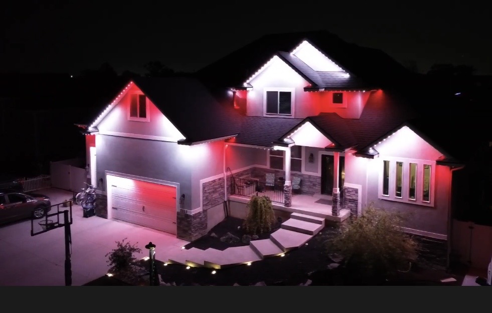 Red + White at Night permanent roofline lighting on a home