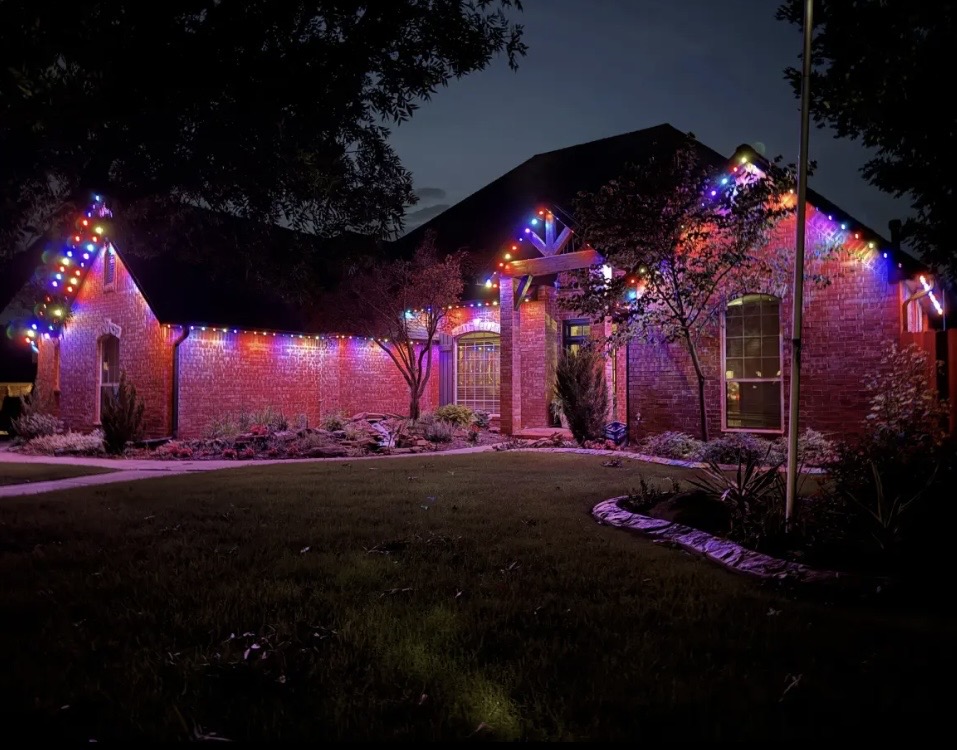 Multicolor permanent roofline lighting on a home