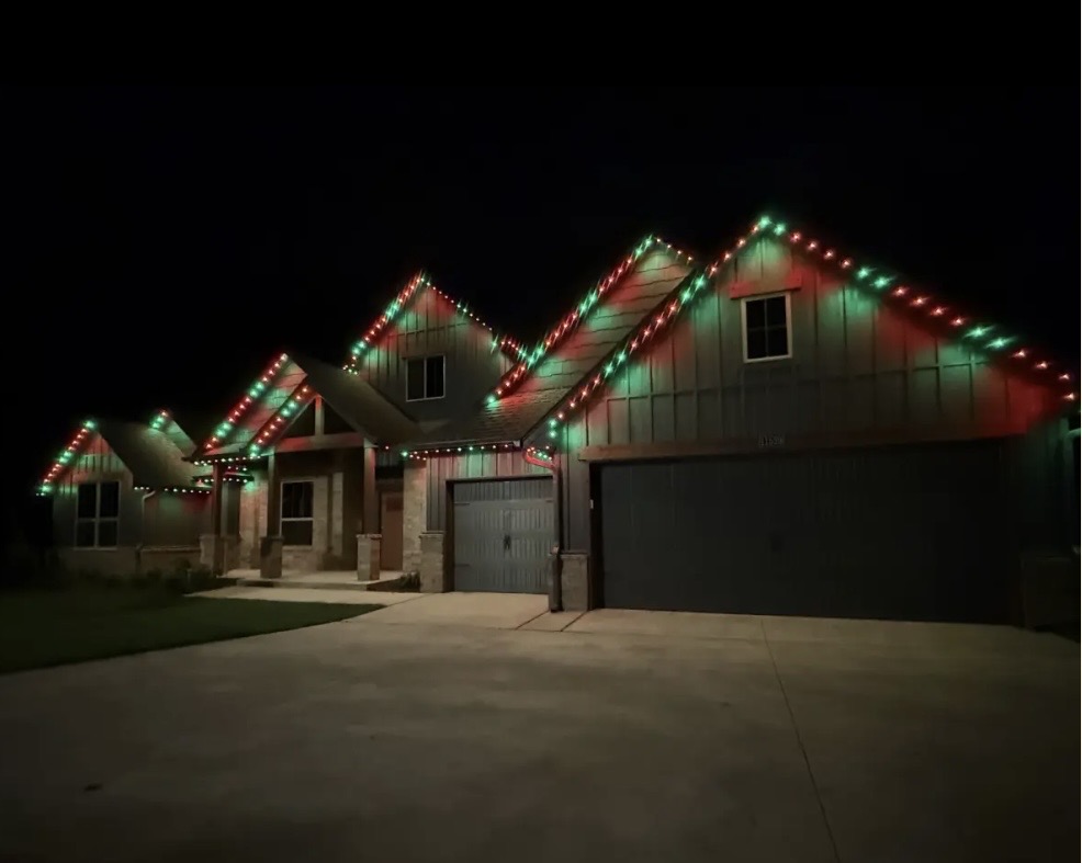 Christmas Red + Green permanent roofline lighting on a home